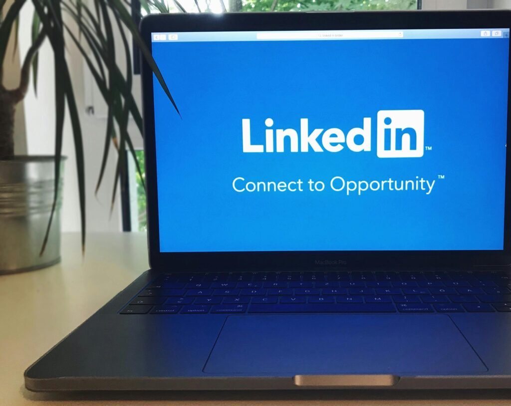A laptop screen displaying the LinkedIn logo with the text 